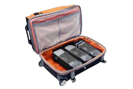 Three slim packing cubes in luggage